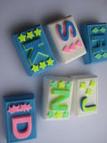 Alphabet letters secured to a rectangle shaped soap bar.